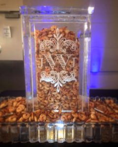 An ice tower with a JWJ monogram and filled with shrimp