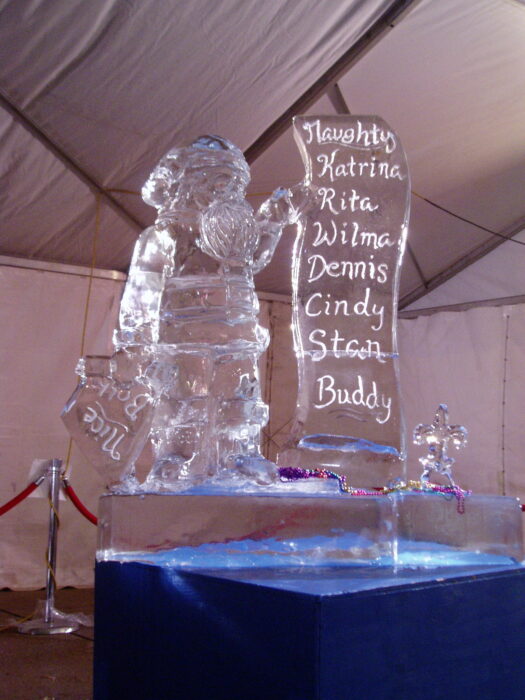 ice sculpture of Santa holding up a list of mostly hurricane names, including Katrina and Rita