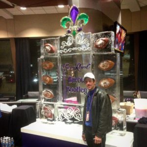 Joe Rimer stands in front of a large Crown Royal Bayou Bootleg ice sculpture at Super Bowl XLVII