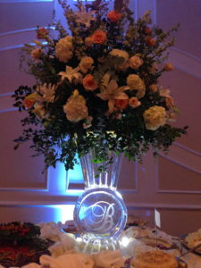 sculpted ice vase with a B monogram and a huge floral arrangement at a wedding in Baton Rouge
