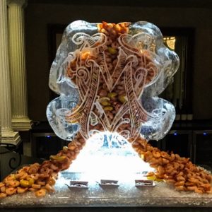 shrimp flowing out of a monogram ice sculpture for a wedding