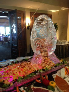 An Easter egg ice sculpture at Metairie country club with shrimp flowing out of it