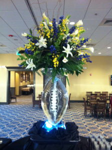 football ice vase combines ice and flowers at Manning's Sports Bar & Grill in New Orleans. by ice dragon ice sculptures