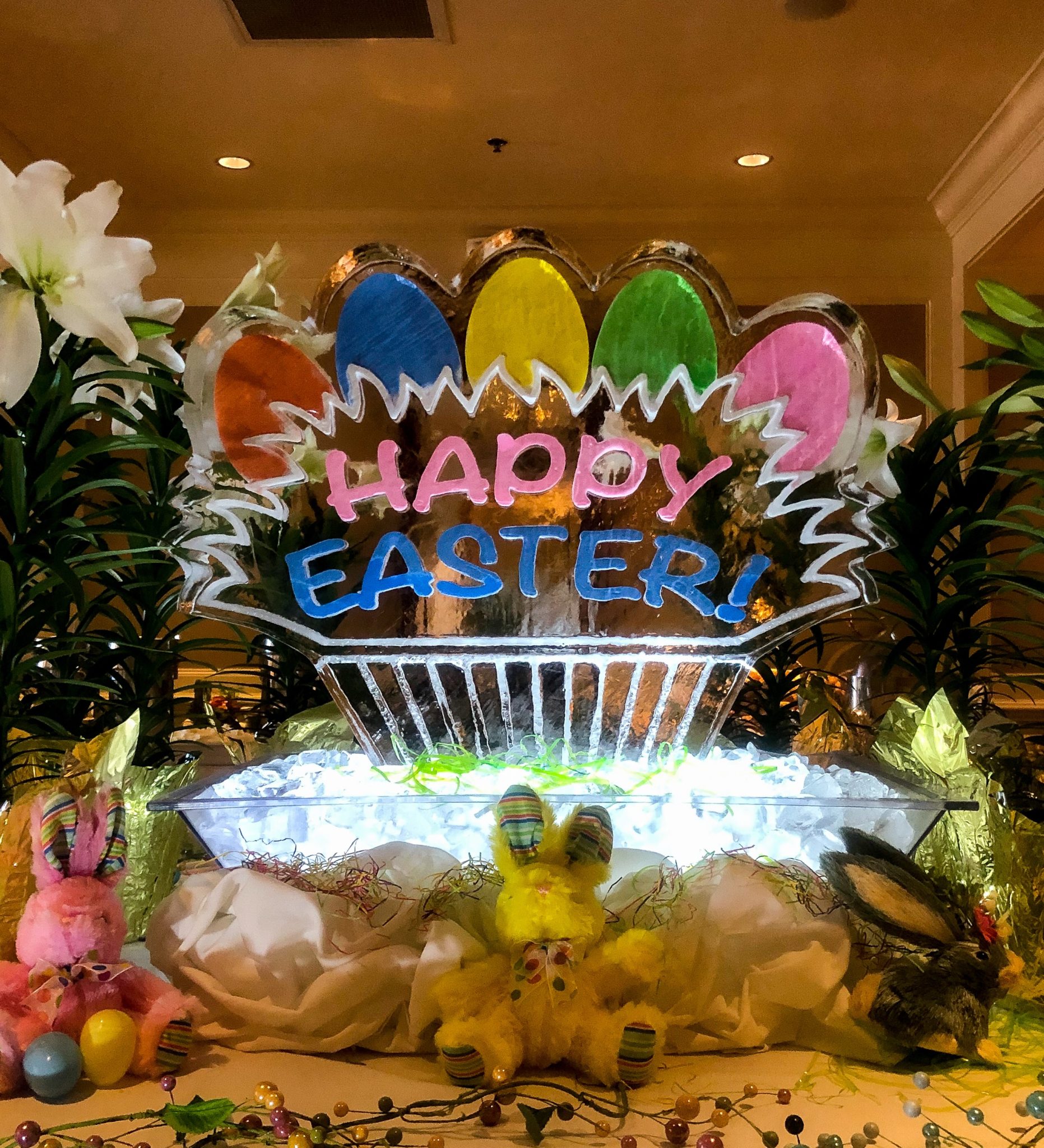 Happy Easter holiday ice sculpture, with color eggs and lettering