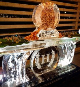 a shrimp luge sits atop a bar sculpted from ice