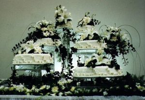 multi-tiered, floral decorated wedding cake displayed on ice sculpted stands