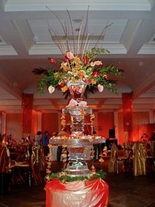 an ice fountain with flowers at a wedding in New Orleans. By ice dragon ice sculptures