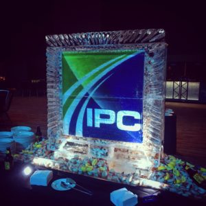 a logo ice sculpture is filled with shrimp