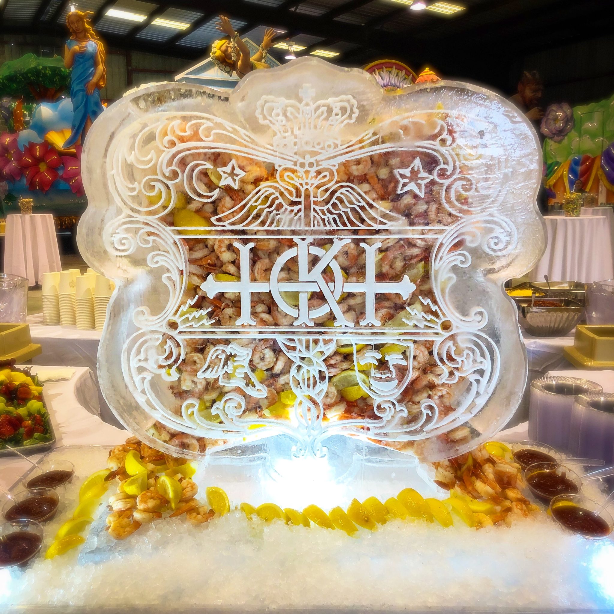 shrimp flows out both sides of a Krewe of Hermes ice sculpture