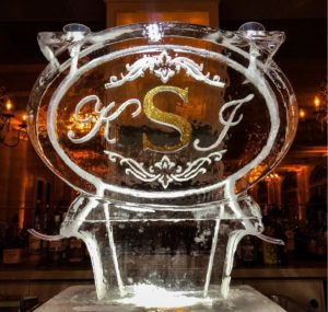 gold monogrammed (KSJ) oval double ice luge on the bar at the wedding reception at Marche
