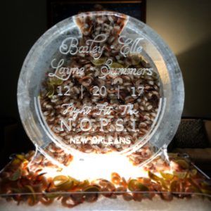 a large round ice sculpture is filled with shrimp