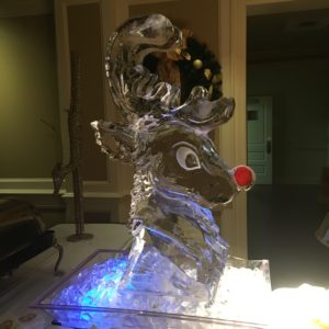 bust ice sculpture of Rudolph and his red nose at a holiday party at Metairie Country Club