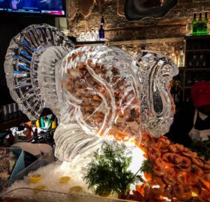This turkey ice sculpture dispenses cold shrimp at a Thanksgiving buffet.