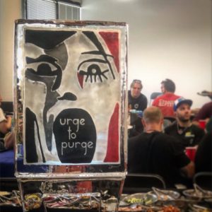 wrap party ice sculpture for The Purge by ice dragon ice sculptures. With a screaming face graphic and the words "urge to purge"