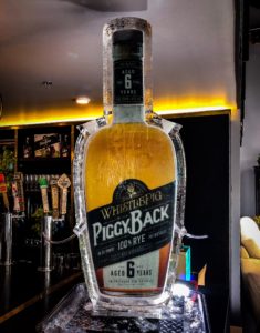 a Whistlepig Piggyback rye whiskey bottle ice luge at a event in New Orleans' Bywater