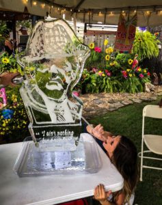 girl does a shot off of a Bear Bryant ice luge