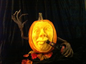 sculpted pumpkin drinking a beer