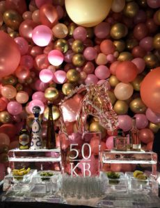 a balloon background sets off a horse head premium tequila ice bar by ice dragon ice sculptures.
