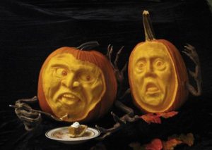 sculpted pumpkin getting ready to eat pumpkin pie while a horrified pumpkin watches