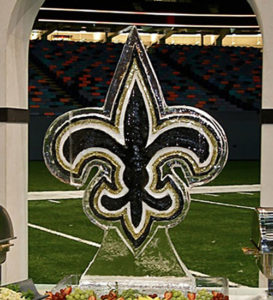 a black on gold Saints fleur de lis for an event on the field at the Superdome