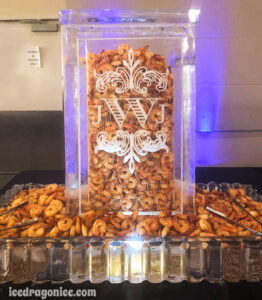 An ice tower with a JWJ monogram and filled with shrimp