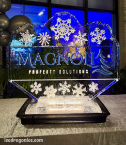 Magnolia Property Solutions logo ice sculpture by ice dragon ice sculptures. At a holiday party in Baton Rouge