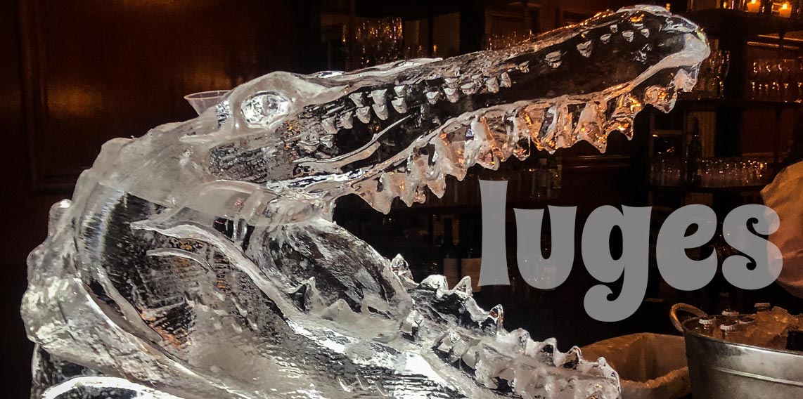 luges title graphic with a alligator head ice luge in the background