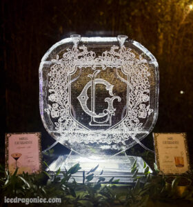 a signature drink double ice luge with an elaborate engraved LG crest at an outdoor wedding on the Northshore (New Orleans metro area)