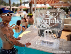 a Don Julio branded tequila luge placed at the edge of a pool bar